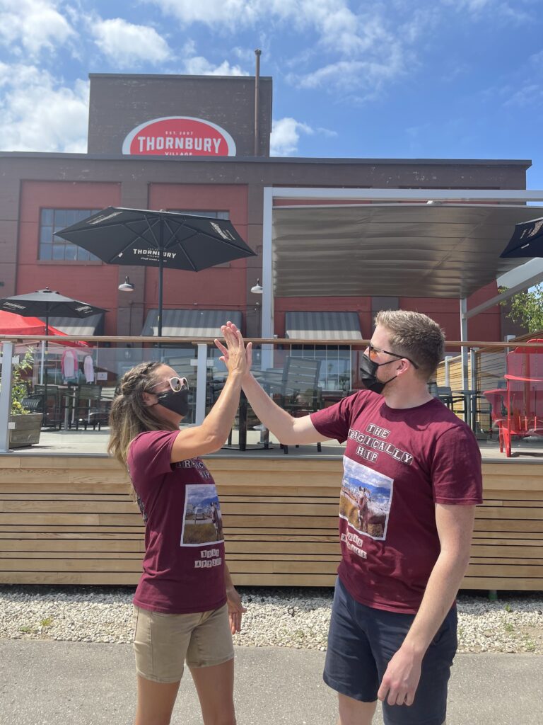 Thornbury Staff doing a high five on the patio